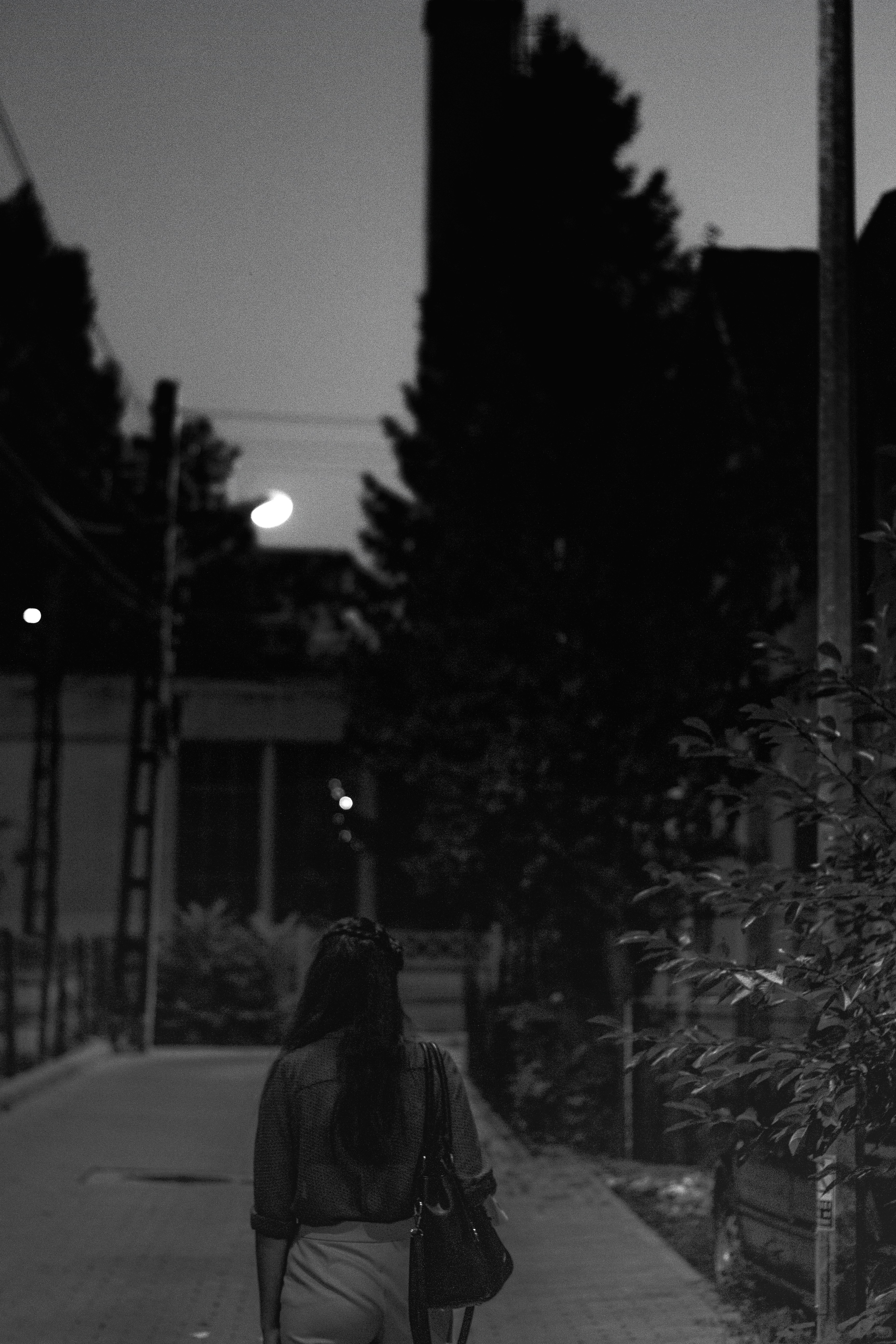 gray-scale photo of woman wearing bag